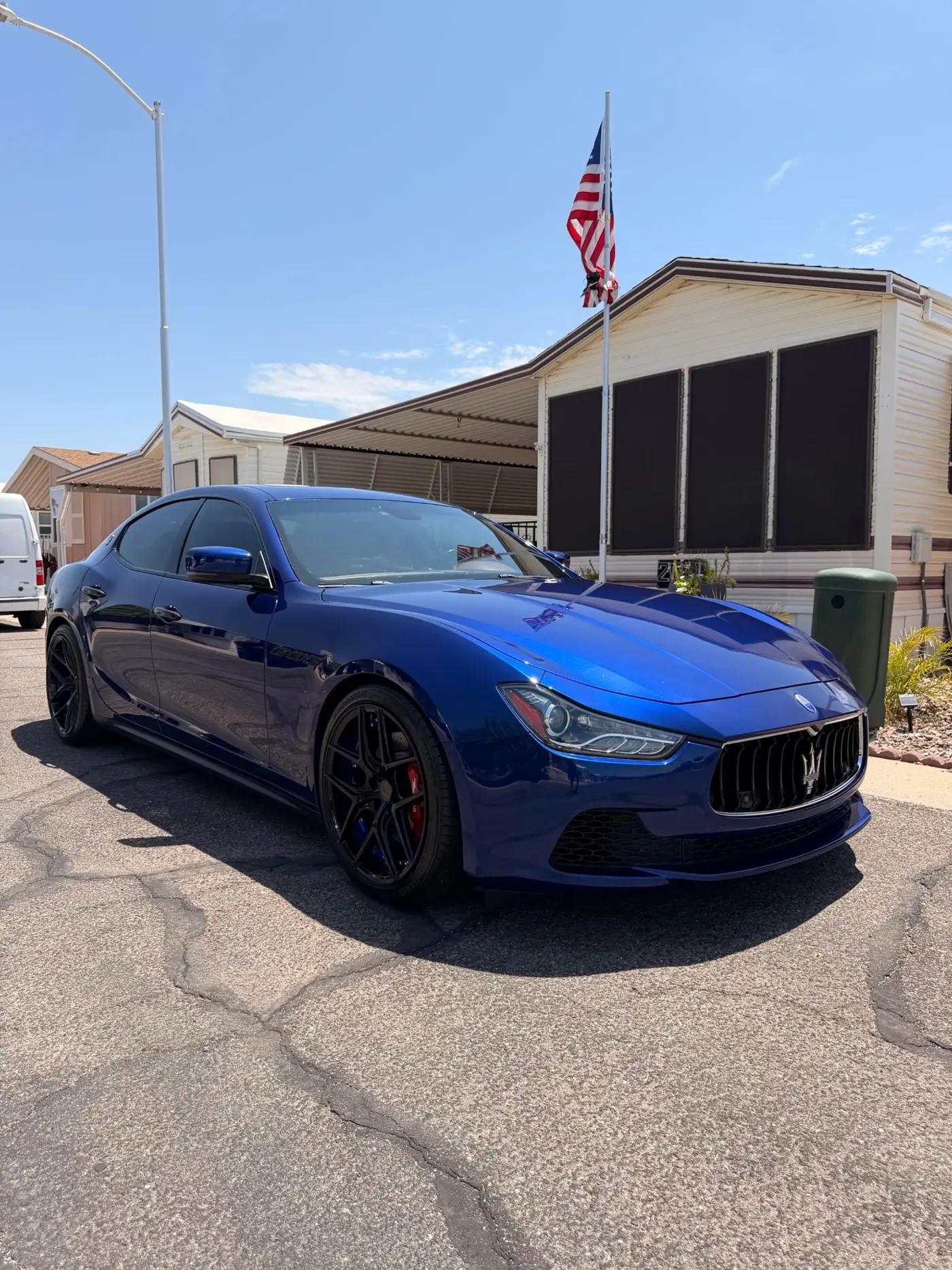 Ceramic coated blue Maserati Ghibli gleaming under Phoenix sun