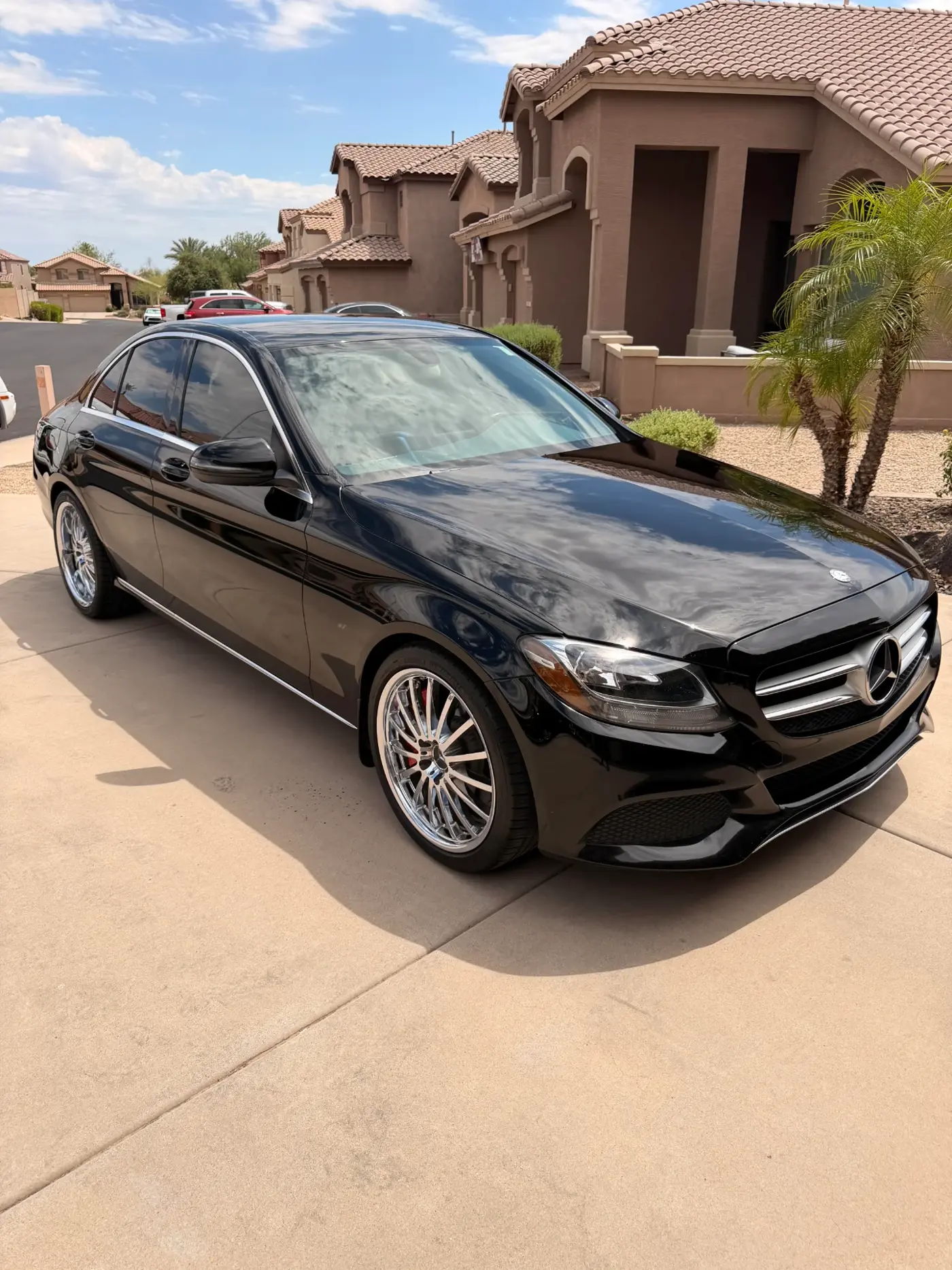 Black Mercedes-Benz C-Class with a mirror-gloss ceramic coated finish in an Arizona driveway